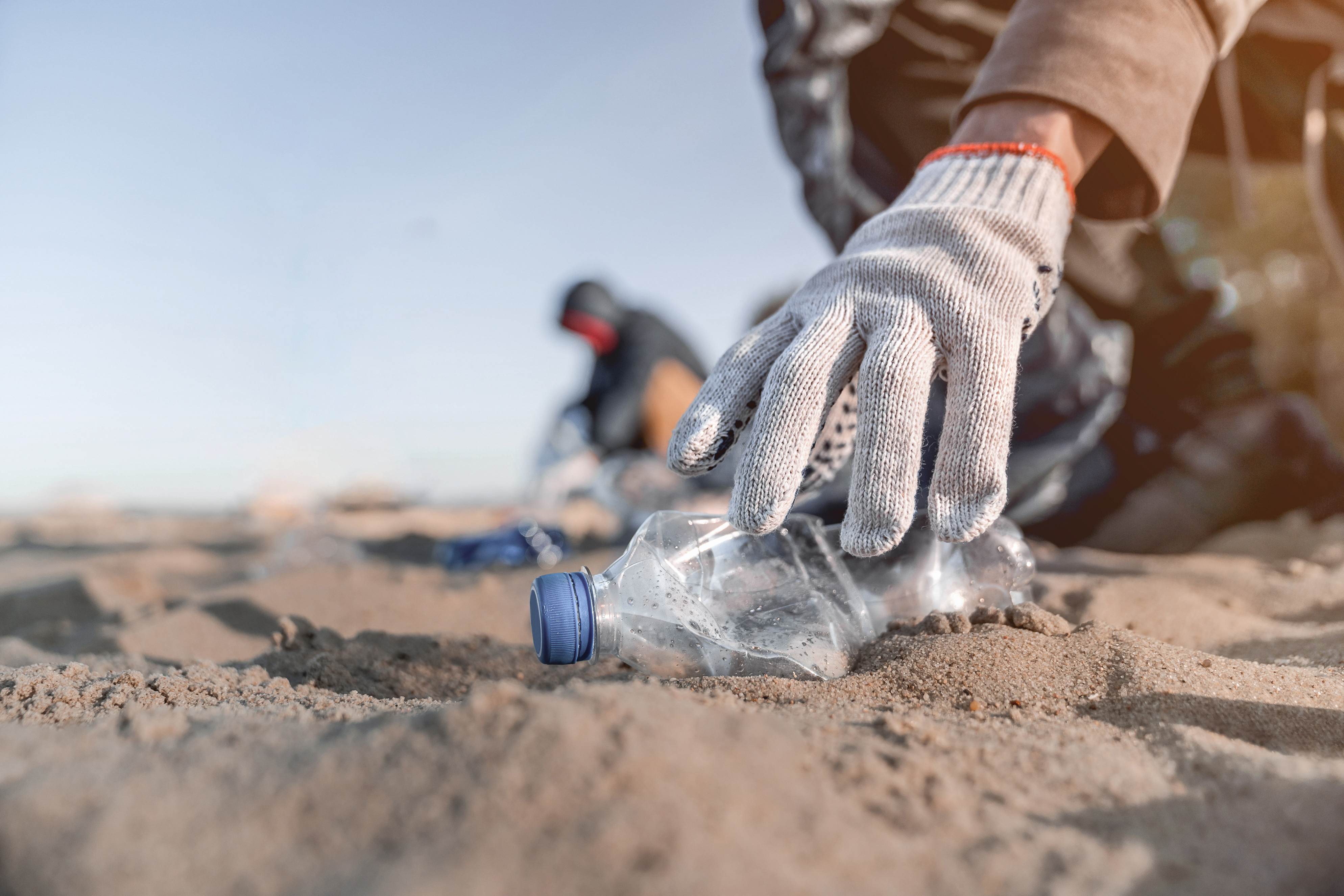 people picking up plastic bottle